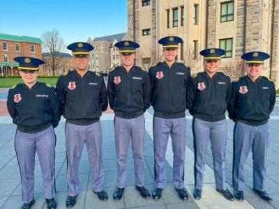 The five cadets are in their white shirt uniform with black jackets on Upper Quad.  